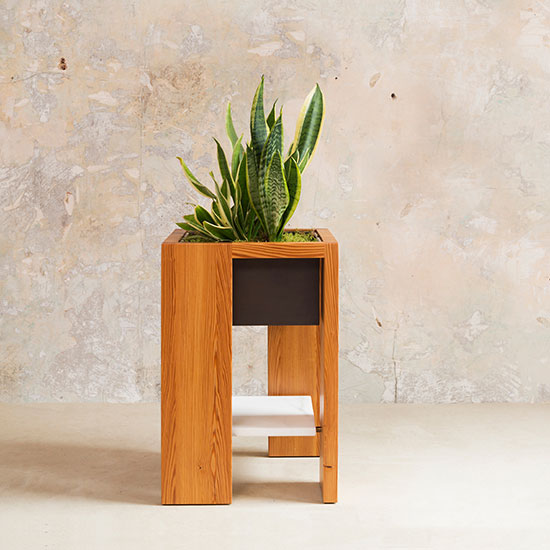 Part of the Box Table Series, The Leon Plant Stand is a hand-crafted, adaptable wood frame table that features a bronze box insert to be used as a planter.