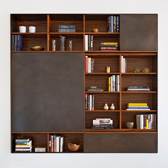 This timeless, adaptable, and thoughtfully crafted modular wall unit offers discrete storage behind wood or metal-clad sliding panels alongside open shelves.